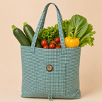 A green and white gingham reusable tote bag filled with fresh vegetables, including zucchinis, tomatoes, lettuce, and a yellow bell pepper, set against a solid beige background.